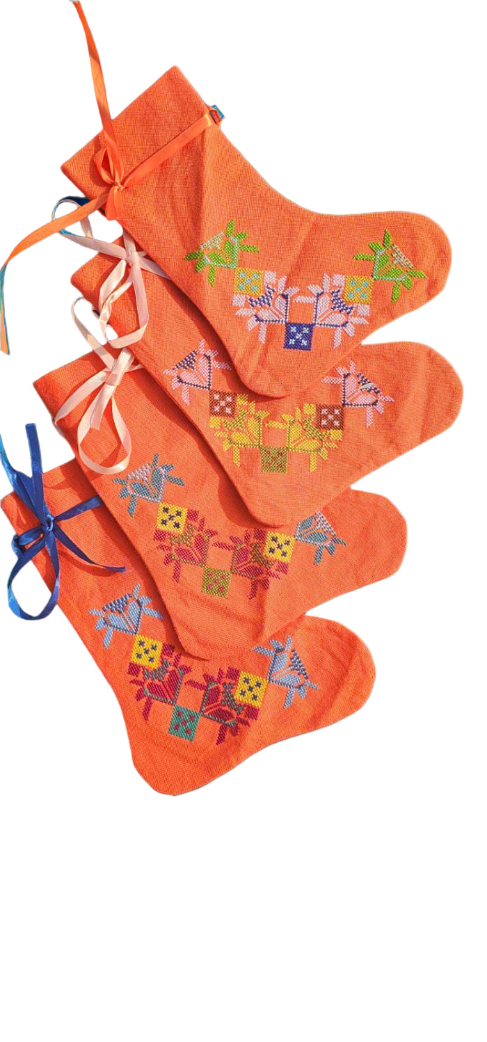 Set of orange socks with colorful patterns on a gray background