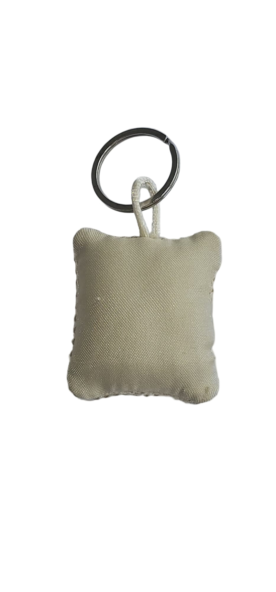 Small beige fabric keychain on a light gray background