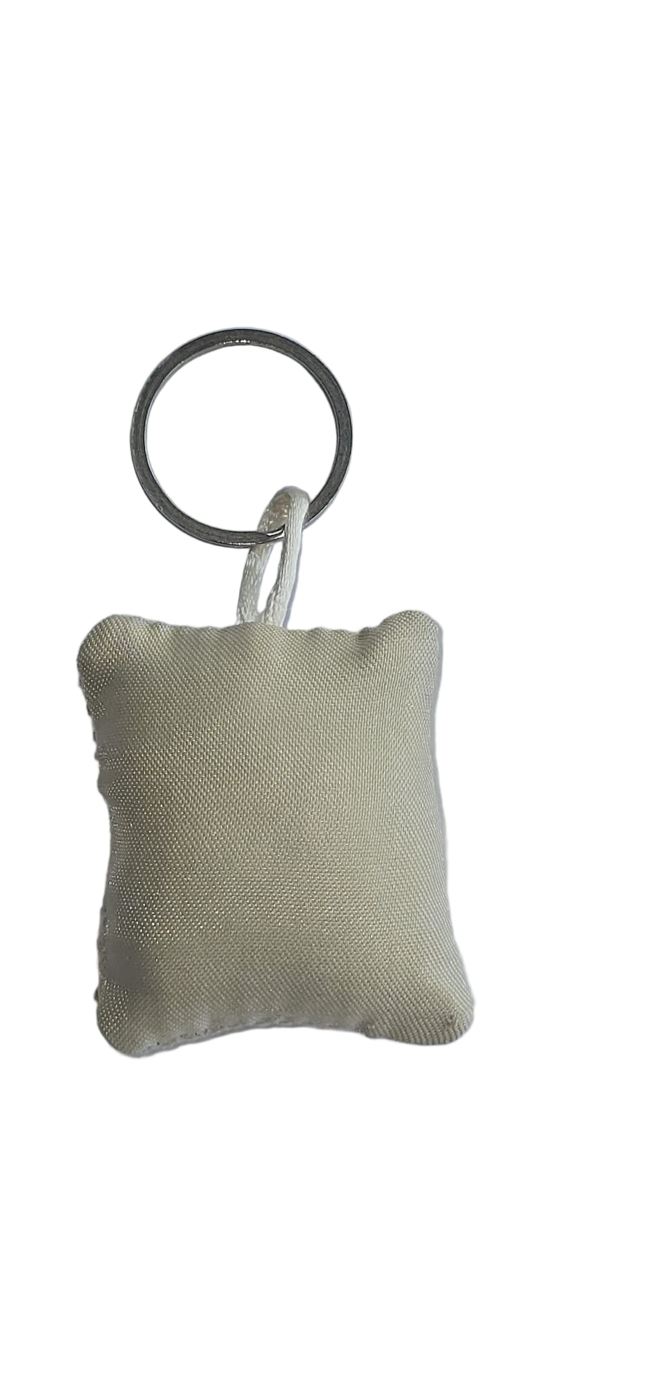 Small beige fabric keychain on a white background